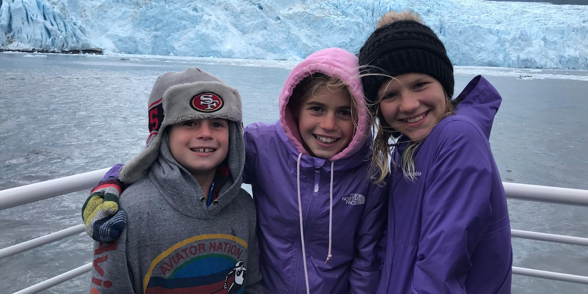 Family group on board the Kenai Fjords cruise in front of a glacier